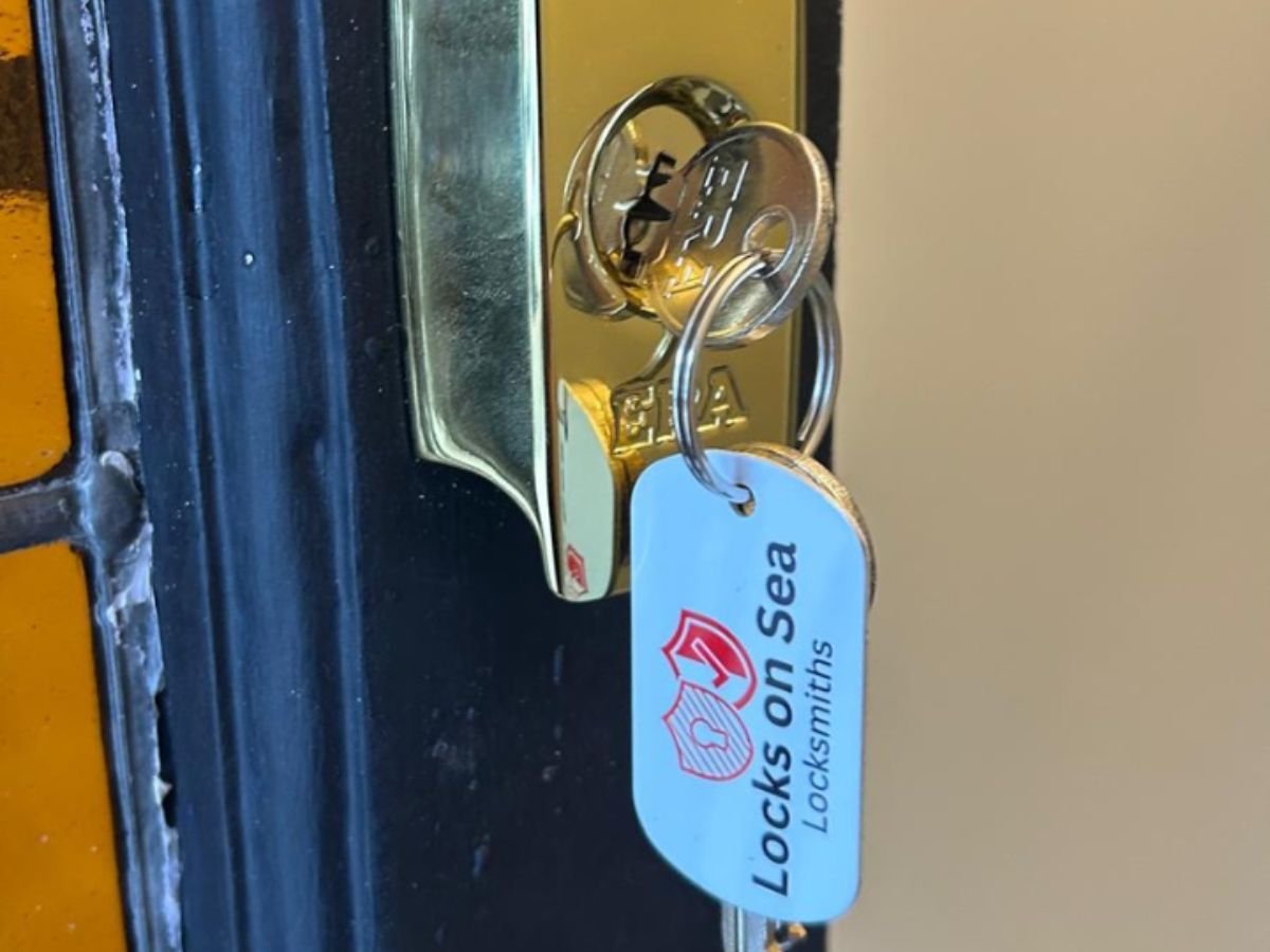 Brand new gold plated euro cylinder lock for southend home. Newly cut ERA key with spares with locks on sea red and white branded key ring dangling from lock.